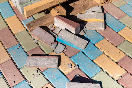 Multi-colored paving slabs. Pavement repairs and paving slabs laying on the roadway, with tile cubes...