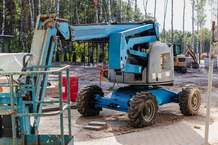 The work of people is at a height. Facade decoration of the building. Self-propelled construction...
