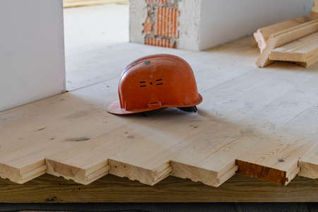 Installation of a wooden floor from boards. Partially completed floor. Natural materials in construction. Environmentally friendly floorの写真素材