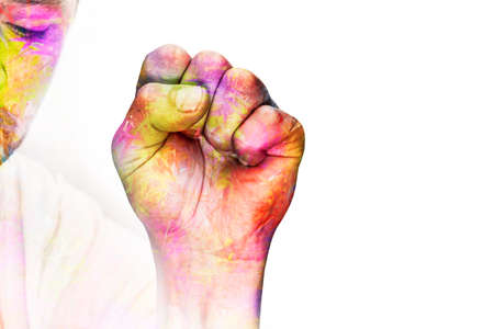 A man's hand is clenched into a fist with the LGBT rainbow flag. The concept of tolerance and acceptance of homosexuality and same-sex love. Equal rights for sexual minorities. Struggle and protestの写真素材