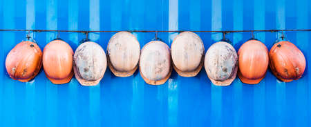 Builders' helmets hang from the utility room during lunchtime. Work safetyの写真素材
