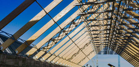 Blasted industrial roofing and rafter system of wooden beams. Huge beams. The construction of...