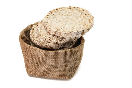 Fitness crispbread in a canvas bag isolated on a white background. Healthy diet food. Whole grain crispy bread. Diet breadの写真素材