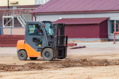 Compact forklift for loading and unloading on a construction site. Equipment for moving goods in a...