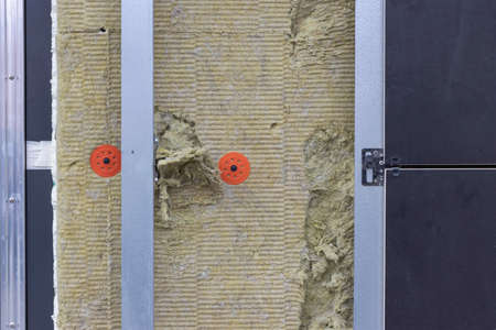 Power saving technology: plates of mineral wool on the side wall, between the metal profiles for attaching the ventilated facadeの写真素材