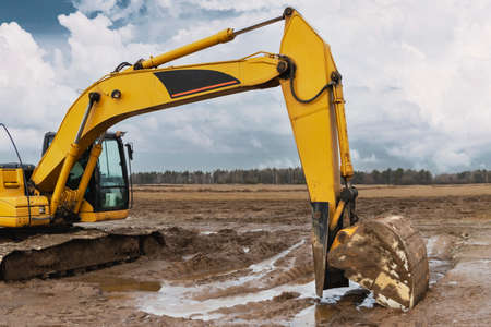 Heavy excavators at a construction site. Construction equipment for earthworks. Quarry excavator. Improvement of the territory and earthworksの写真素材