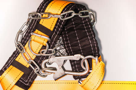 Safety belt for work at height with carabiner. Professional safety equipment for mountaineering and construction. safety precautions. close-upの写真素材
