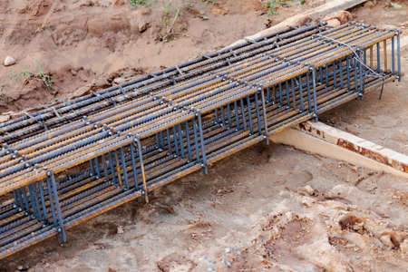Steel frames and reinforcing mesh are stored at the construction site. Preparation for the...