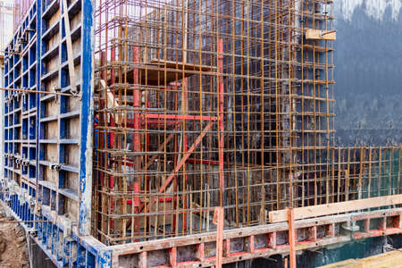 Reinforced concrete foundation of a modern monolithic residential building. Prepared formwork with...