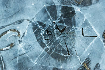 Pieces of ice in nature. Chunks of cracked ice closeup. Broken ice on the lake. Pieces of ice close...