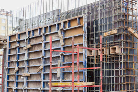 Reinforced concrete foundation of a modern monolithic residential building. Prepared formwork with...