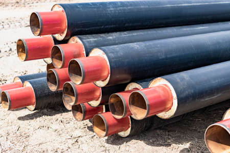 insulated pipe. Large metal pipes with a plastic sheath at a construction site. Modern pipeline for...