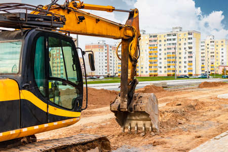 A heavy crawler excavator with a large bucket is getting ready for work. Heavy construction...