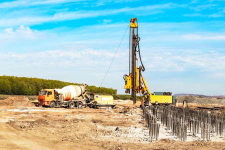Hydraulic drilling machine at the construction site makes piles. Pile field. Modern drilling rigの写真素材