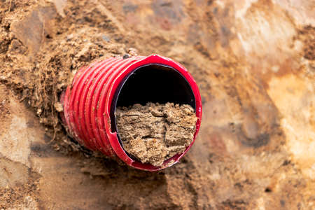 Water pipes for drinking water supply lie on the construction site. Preparation for earthworks for laying an underground pipeline. Modern water supply systems for a residential cityの写真素材