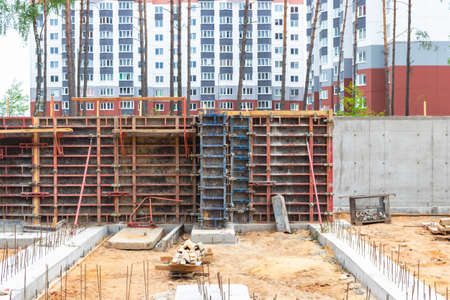 Reinforced concrete foundation of a modern monolithic residential building. Prepared formwork with reinforcing mesh for pouring concrete. Monolithic construction technologiesの写真素材