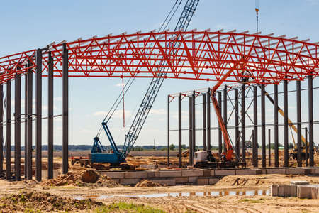 Installation of metal trusses and frame during the construction of an industrial building or...