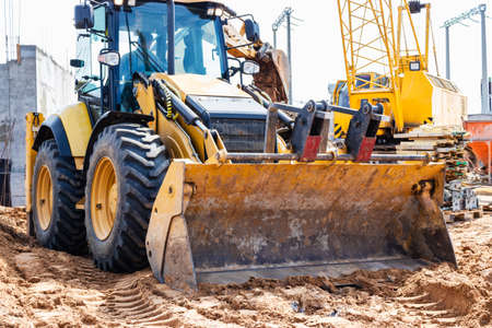 Excavator digs piles. Earthworks for the construction of the foundation. Construction equipment for...