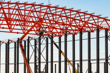 Installation of metal trusses and frame during the construction of an industrial building or...