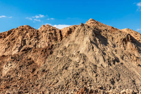 Heap of earth sand and clay at the construction site against the sky. Earthworks at the construction siteの写真素材