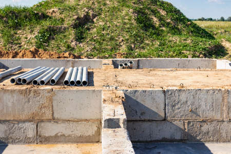 Strip foundation of a new building from concrete foundation blocks. The foundation for the...