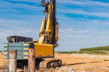 Hydraulic drilling machine at the construction site. Pile field. Modern drilling rig. The device of...