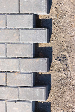 Pavement repairs and paving slabs laying on the prepared surface, with tile cubes in the background....
