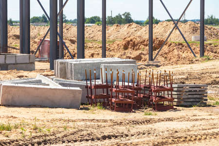 Building materials at a construction site. Prepared materials and embedded parts for foundations at...