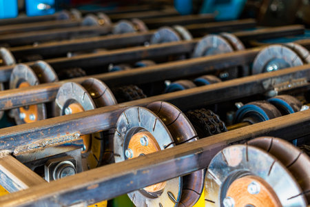 Rolls of an industrial machine for cutting metal. Conveyor line in a factory for processing sheet...
