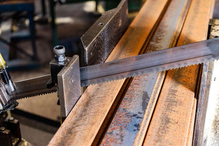 Machine for cutting metal profile. The saw cuts metal blanks into pieces. Industrial equipment for cutting and processing metalの写真素材