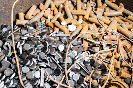 Metal waste in production. background. Waste metal on a stamping press. Recycling of metal waste at...