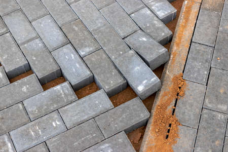 Pavement repairs and paving slabs laying on the prepared surface, with tile cubes in the background....