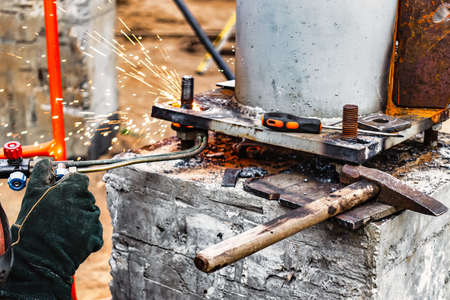 Worker cutting metal plate by Gas Cutting Torch in the workshop.Worker cutting metal plate by Gas...