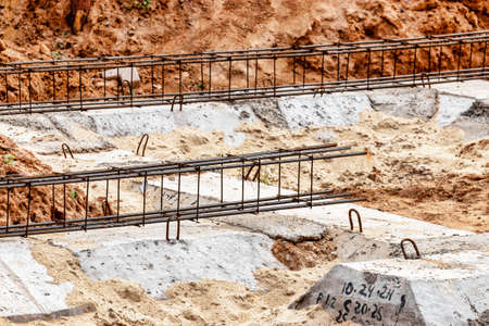 Reinforced concrete foundation of a modern monolithic residential building. Prepared formwork with...