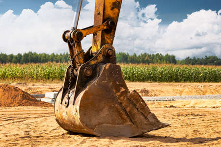 Close up of excavator bucket at construction site. Construction equipment for earthworks