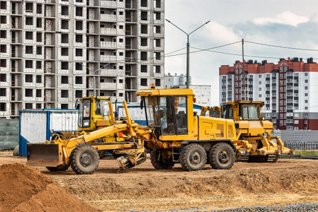 Road grader at the construction site. Powerful construction machine for ground leveling and excavation. close-up. professional construction equipmentの写真素材