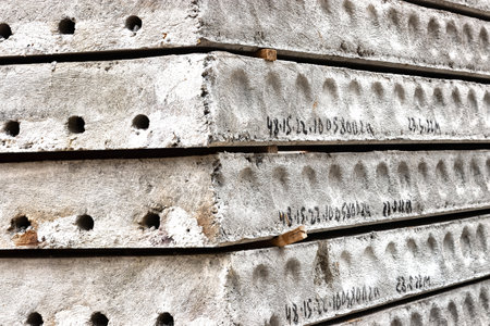 Reinforced concrete floor slabs are stored at the construction site. close-up. Reinforced concrete building structures and materialsの写真素材