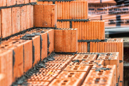 Red ceramic bricks at the construction site. Keramoblock. Hollow brick. Construction of a red brick...