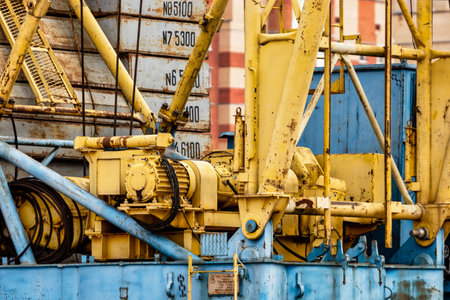 A large tower crane at a construction site against the backdrop of a modern monolithic house. Modern housing construction. industrial engineering. Construction of mortgage housingの写真素材
