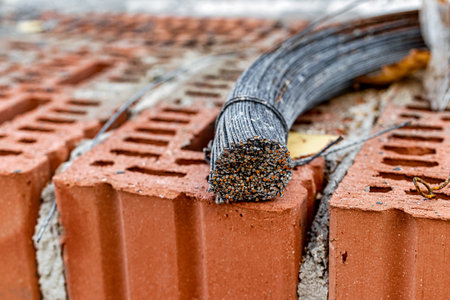Use of knitting wire for reinforcement in the construction of a house. The prepared knitting wire lies on the brickwork. Armature bond. close-upの写真素材