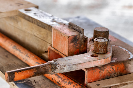 Manual machine for bending reinforcement. close-up. Reinforcement bending in construction conditions. Mechanism for bending steel rodsの写真素材