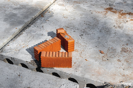 Red ceramic bricks at the construction site. Keramoblock. Hollow brick. Construction of a red brick building. close-up. Material for the construction of walls and partitionsの写真素材