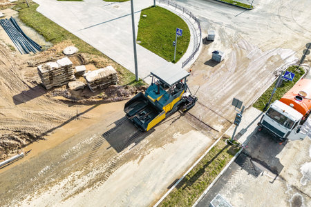 Asphalt laying equipment. Asphalt paver machine on the road repair site. Road renewal process, construction work. view from above. drone photographyの写真素材