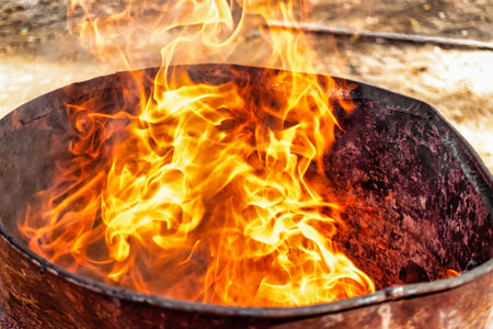 Burning fire in a barrel close-up. bright flame. open flame heating. Problems with heating and gas