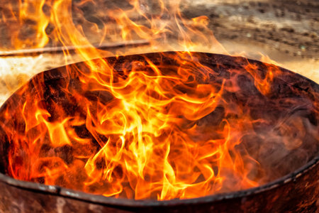 Burning fire in a barrel close-up. bright flame. open flame heating. Problems with heating and gasの写真素材