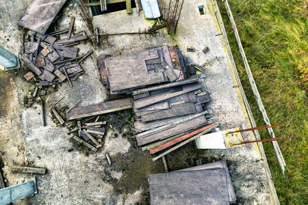 Abandoned construction site of a reinforced concrete monolithic house. Abandoned building materials. Stop financing construction. Shooting from a droneの写真素材
