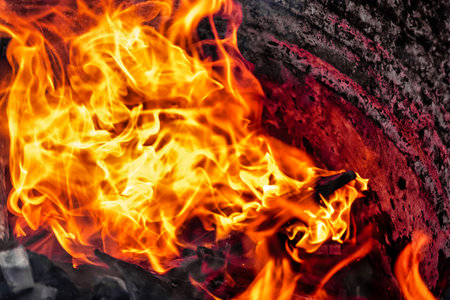 Burning fire close up. Bright orange and red flames on a dark background. open flame heating. Problems with heating and gasの写真素材