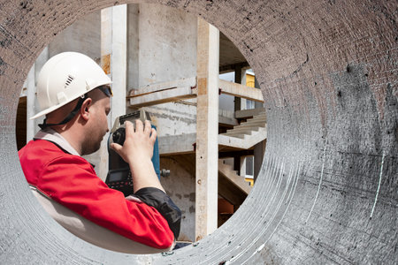 Surveyor engineer is measuring level on construction site. Surveyors ensure precise measurements...