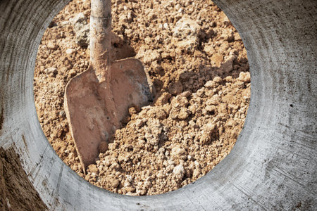 Construction shovel in a pile of sand close-up. working building tool. Builder's hand tool. sand and...