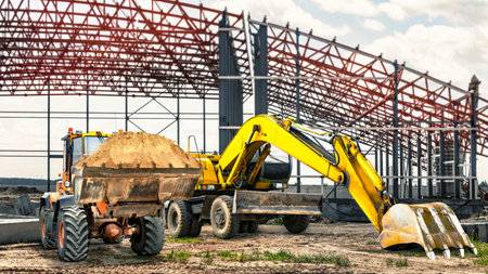 Excavator and bulldozer loader close-up on a modern frame shop under construction. Construction equipment for earthworks. Rent of modern construction equipmentの写真素材